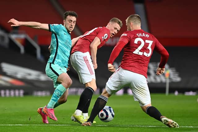 Scott McTominay (centre) in action alongside his Manchester United team-mate Luke Shaw (right) against Liverpool's Diogo Jota (left) last month. McTominay and Shaw could face each other at Wembley in Friday's England-Scotland Euro 2020 showdown.  (Photo by Michael Regan/Getty Images)