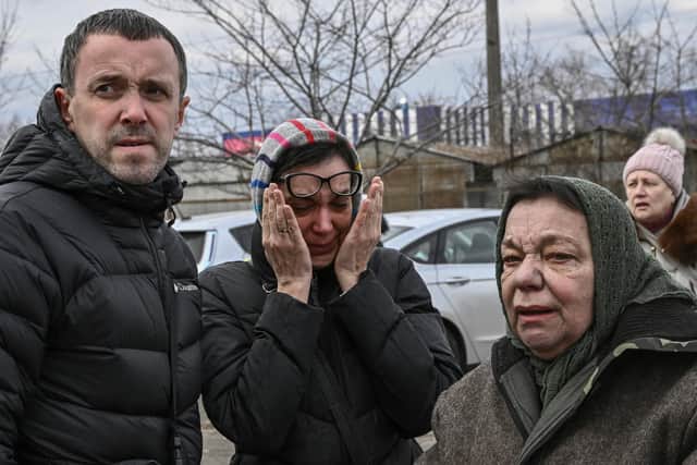 A woman weeps in Kyiv after the latest attacks by Russian forces (Picture: Aris Messinis/AFP via Getty Images)