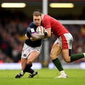 Stuart Hogg of Scotland is tackled by Owen Watkin of Wales during the Guinness Six Nations match between Wales and Scotland at Principality Stadium on February 12, 2022.