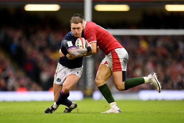 Stuart Hogg of Scotland is tackled by Owen Watkin of Wales during the Guinness Six Nations match between Wales and Scotland at Principality Stadium on February 12, 2022.