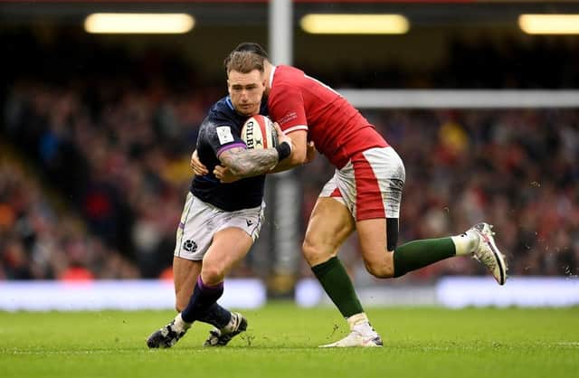 Stuart Hogg of Scotland is tackled by Owen Watkin of Wales during the Guinness Six Nations match between Wales and Scotland at Principality Stadium on February 12, 2022.