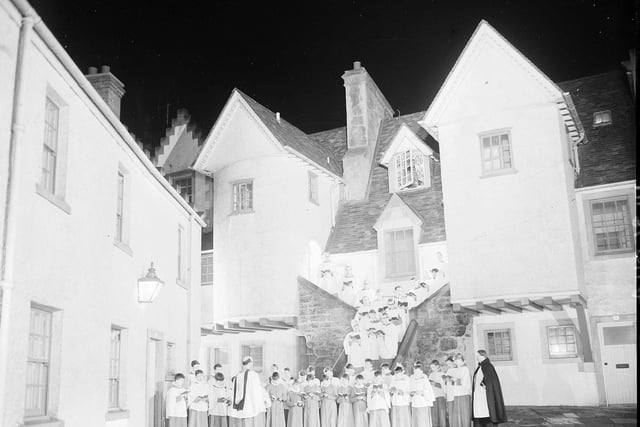 A choir from St Mary's Episcopal Cathedral sing Christmas carols in Edinburgh's White Horse Close in 1965.