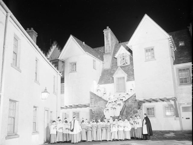 A choir from St Mary's Episcopal Cathedral sing Christmas carols in Edinburgh's White Horse Close in 1965.