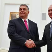 Russian President Vladimir Putin,  right, shakes hands with ally Hungary's Prime Minister Viktor Orban during a meeting at the Kremlin in Moscow