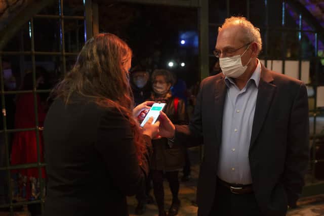 A man presents his 'green passport', proof that he has been vaccinated against the Covid-19 coronavirus at a theatre in Jerusalem. The idea is being considered in the UK (Picture: Maya Alleruzzo/AP)