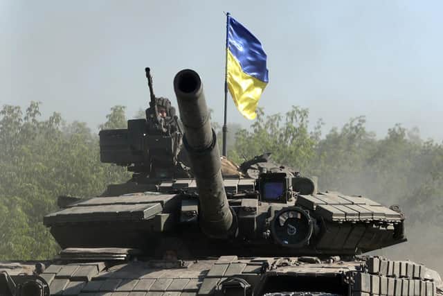 Ukrainian troop ride a tank on a road of the eastern Ukrainian region of Donbas on June 21, 2022, as Ukraine says Russian shelling has caused "catastrophic destruction" in the eastern industrial city of Lysychansk. Photo by Anatolii Stepanov via Getty Images