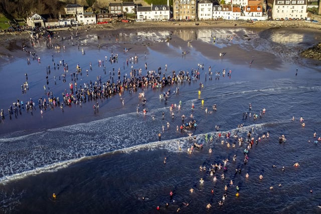 People take part in a Loony Dook New Year's Day dip in the Firth of Forth at Kinghorn in Fife.
