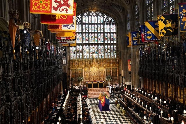 The coffin of Queen Elizabeth II, draped in the Royal Standard with the Imperial State Crown and the Sovereign's orb and sceptre, during the Committal Service at St George's Chapel in Windsor Castle