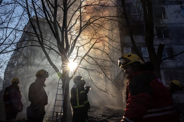 Firefighters work to extinguish a fire at a residential apartment building after it was hit by a Russian attack in the early hours of the morning  on March 15, 2022 in Kyiv,  (Photo by Chris McGrath/Getty Images)