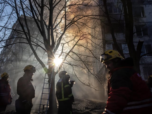 Firefighters work to extinguish a fire at a residential apartment building after it was hit by a Russian attack in the early hours of the morning on March 15, 2022 in Kyiv, (Photo by Chris McGrath/Getty Images)