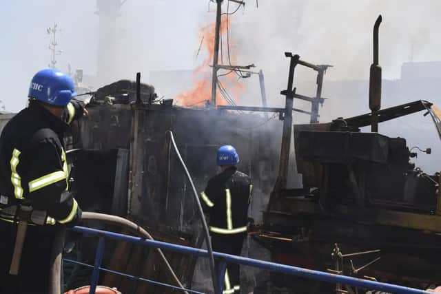 Firefighters put out a fire in a port after a Russian missiles attack in Odesa, Ukraine, on Saturday. Picture: Odesa City Hall Press Office via AP
