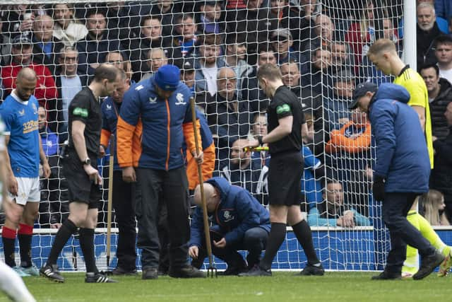 Rangers groundstaff inspect the pitch for glass after a bottle is thrown during a cinch Premiership match between Rangers and Celtic at Ibrox Stadium, on April 02, 2022, in Glasgow, Scotland.  (Photo by Rob Casey / SNS Group)