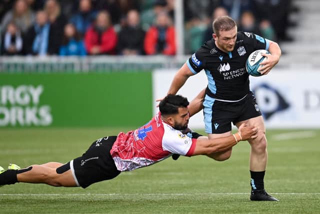 Glasgow's Nick Grigg powers past Lion's Stean Pienaar at Scotstoun on Saturday.  (Photo by Rob Casey / SNS Group)