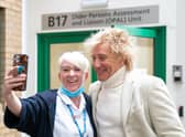 Sir Rod Stewart poses for photos with members of staff at the Princess Alexandra Hospital in Harlow, Essex