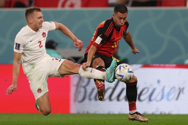 Canada's Alistair Johnston tackles Belgium's Eden Hazard during the Qatar 2022 World Cup group match. (Photo by ADRIAN DENNIS/AFP via Getty Images)