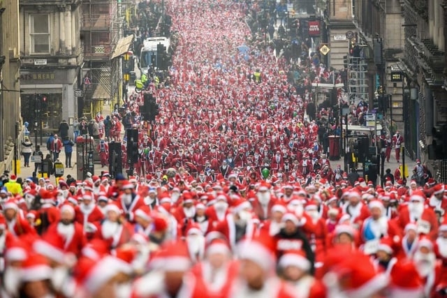 Over eight thousand members of the public take part in Glasgow's annual Santa dash make their way up St Vincent Street in 2017.