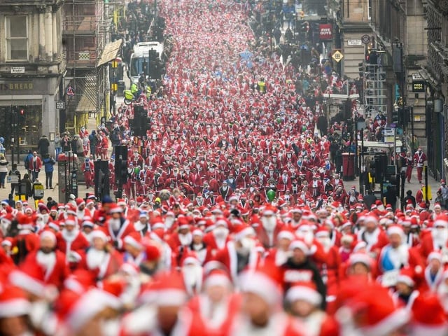 Over eight thousand members of the public take part in Glasgow's annual Santa dash make their way up St Vincent Street in 2017.