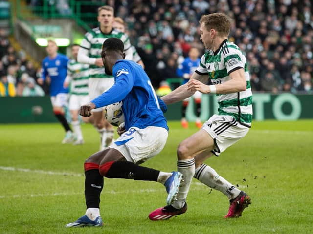 Rangers claim for a penalty after the ball hits the arm of Celtic's Alistair Johnston.