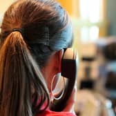 Almost 150,000 NHS 24 calls were abandoned before the caller spoke to an operator in the first half of this year, according to new figures.