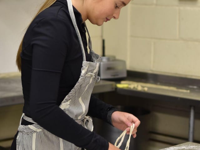 A participant making hand-pulled noodles.