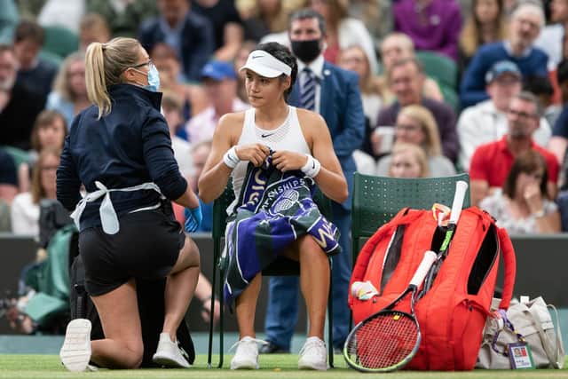 Emma Raducanu receives treatment during a medical time out in the match against Ajla Tomljanovic.