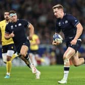 Scotland's fly-half Ben Healy runs with the ball to score a try during the France 2023 Rugby World Cup Pool B match between Scotland and Romania at Pierre-Mauroy stadium in Villeneuve-d'Ascq near Lille, northern France, on September 30, 2023. (Photo by FRANCK FIFE / AFP) (Photo by FRANCK FIFE/AFP via Getty Images)