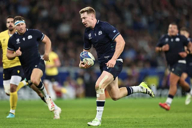 Scotland's fly-half Ben Healy runs with the ball to score a try during the France 2023 Rugby World Cup Pool B match between Scotland and Romania at Pierre-Mauroy stadium in Villeneuve-d'Ascq near Lille, northern France, on September 30, 2023. (Photo by FRANCK FIFE / AFP) (Photo by FRANCK FIFE/AFP via Getty Images)