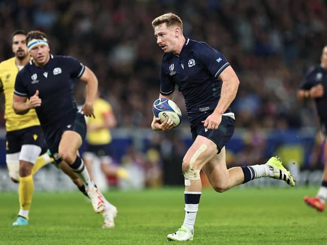 Scotland's fly-half Ben Healy runs with the ball to score a try during the France 2023 Rugby World Cup Pool B match between Scotland and Romania at Pierre-Mauroy stadium in Villeneuve-d'Ascq near Lille, northern France, on September 30, 2023. (Photo by FRANCK FIFE / AFP) (Photo by FRANCK FIFE/AFP via Getty Images)