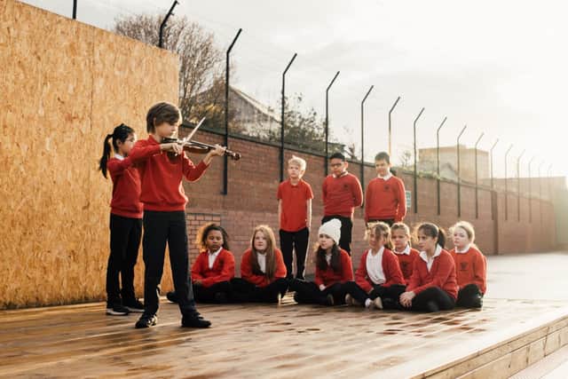 Harris Hawkey and Luo Lin Zheng perform on a new outdoor stage at Hermitage Park Primary in Leith which has been provided by the Edinburgh International Festival. Picture: Ryan Buchanan