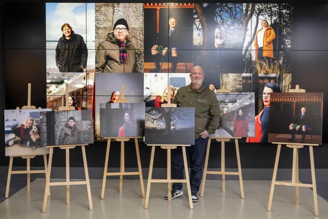 Photographer Chris Scott with work from his Ten Portraits exhibition, featuring images of ten care-experienced people 
