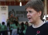 Nicola Sturgeon speaks to members of the media at the finish line of the Running Out Of Time climate relay. Picture: AP Photo/Thomas Hartwell