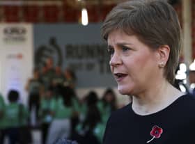 Nicola Sturgeon speaks to members of the media at the finish line of the Running Out Of Time climate relay. Picture: AP Photo/Thomas Hartwell