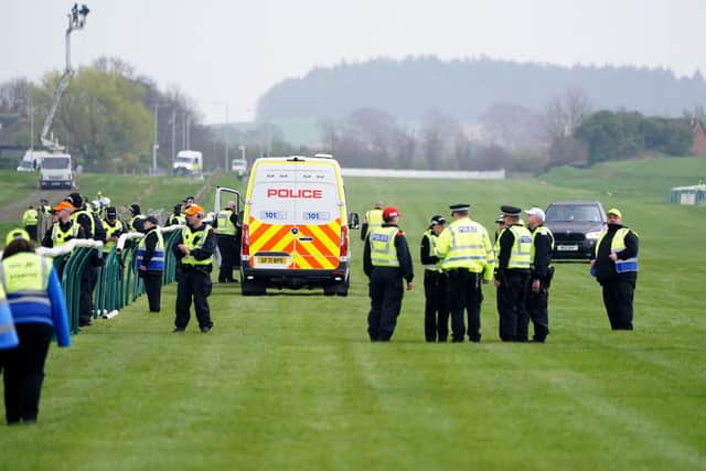 Police officers on the course after Animal Rising activists had to be removed from the track during the Coral Scottish Grand National festival at Ayr Racecourse. Picture: Jane Barlow/PA Wire