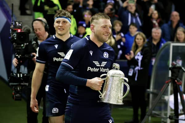 Finn Russell of Scotland with the Calcutta Cup, followed by Rory Darge, after defeating England at Murrayfield  (Picture: David Rogers/Getty Images)