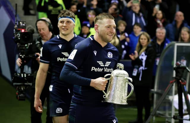 Finn Russell of Scotland with the Calcutta Cup, followed by Rory Darge, after defeating England at Murrayfield (Picture: David Rogers/Getty Images)
