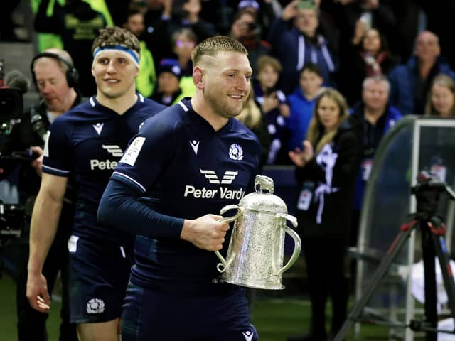 Finn Russell of Scotland with the Calcutta Cup, followed by Rory Darge, after defeating England at Murrayfield  (Picture: David Rogers/Getty Images)