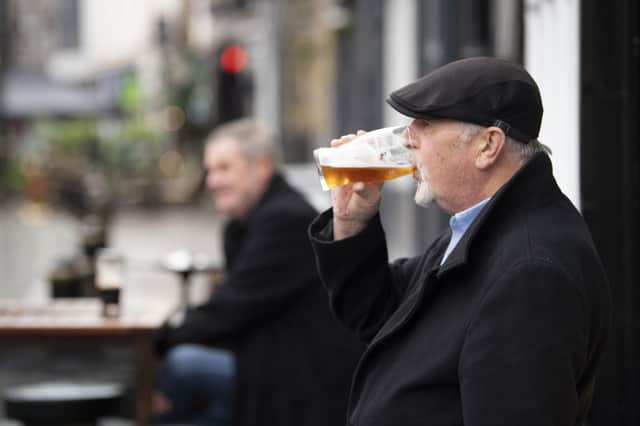 A man drinks a pint as Nicola Sturgeon introduces a new five-tier system of coronavirus restrictions. Picture: Matthew Horwood/Getty Images