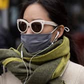 A woman wears a face covering in England after the law was relaxed. Photo by Dan Kitwood/Getty Images