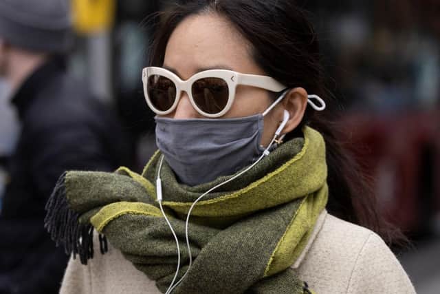 A woman wears a face covering in England after the law was relaxed. Photo by Dan Kitwood/Getty Images