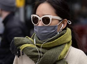 A woman wears a face covering in England after the law was relaxed. Photo by Dan Kitwood/Getty Images