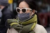 A woman wears a face covering in England after the law was relaxed. Photo by Dan Kitwood/Getty Images