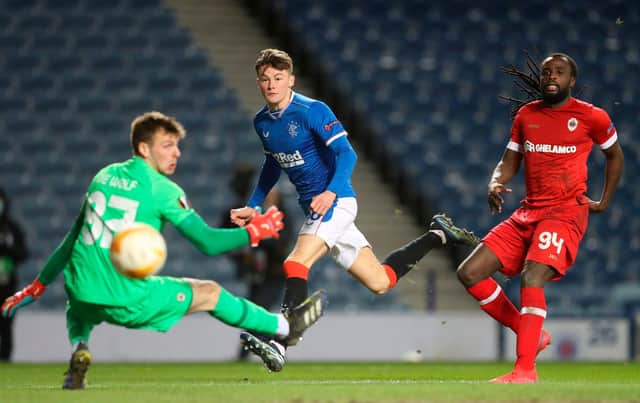 Rangers' Scottish defender Nathan Patterson watches his shot beat Antwerp's Belgian goalkeeper Ortwin De Wolf for their second goal during the UEFA Europa League Round of 32, 2nd leg  match (Photo by RUSSELL CHEYNE/POOL/AFP via Getty Images)