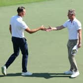 Henrik Stenson and Luke Donald shake hands on the 18th green after playing together in the third round of the Hero Dubai Desert Classic at Emirates Golf Club. Picture: Andrew Redington/Getty Images.