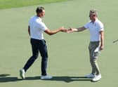Henrik Stenson and Luke Donald shake hands on the 18th green after playing together in the third round of the Hero Dubai Desert Classic at Emirates Golf Club. Picture: Andrew Redington/Getty Images.