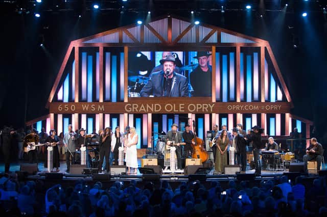 A performance on stage at the Grand Ole Opry House which hosts a live radio show every Saturday.