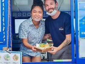 Samwell Galbraith and his wife, Kumi, in their Bonnie Blue van in Japan. PIC: SWNS.