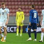 Scotland's Oli McBurnie, goalkeeper Craig Gordon and Scott McKenna appear dejected after the final whistle.