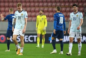 Scotland's Oli McBurnie, goalkeeper Craig Gordon and Scott McKenna appear dejected after the final whistle.