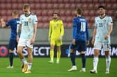 Scotland's Oli McBurnie, goalkeeper Craig Gordon and Scott McKenna appear dejected after the final whistle.