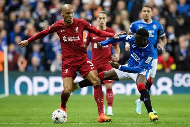Rangers' Fashion Sakala competes with Liverpool's Fabinho during their match at Ibrox.